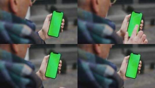 老人滑动绿幕手机的特写高清在线视频素材下载