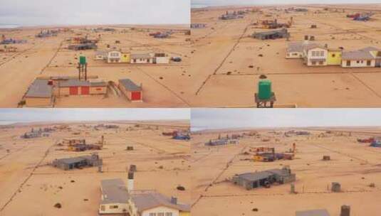 航拍沙漠中的几栋房屋建筑高清在线视频素材下载