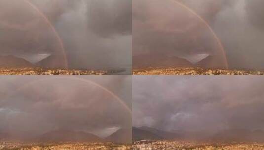 城市上空华丽的粉红色日落地平线上的雨和美丽的双彩虹鸟瞰高清在线视频素材下载