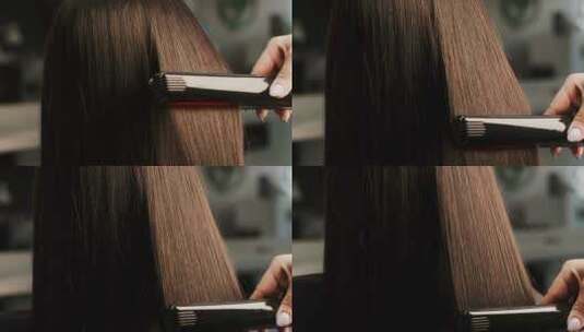 女人用直发器烫头发特写高清在线视频素材下载
