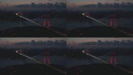 土耳其伊斯坦布尔博斯普鲁斯海峡大桥红光照明的广角拍摄，航拍高清在线视频素材下载