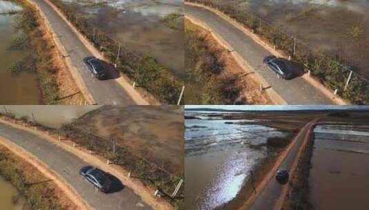 汽车行驶在稻田中间的乡村道路上，无人机视高清在线视频素材下载