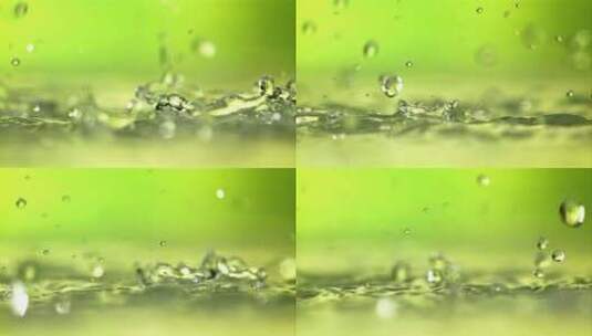 水滴飞溅在绿色背景上的表面高清在线视频素材下载