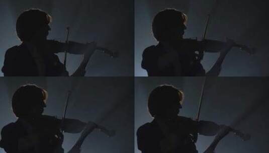 小提琴手在黑暗的工作室里用灯笼表演高清在线视频素材下载