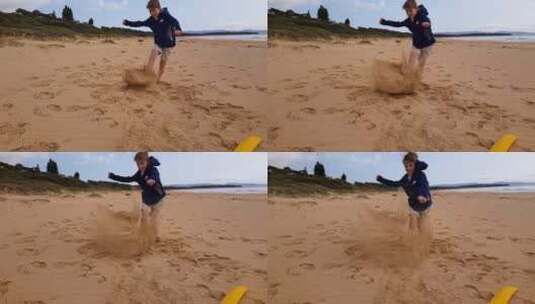 赤脚男孩踢海滩上的沙子高清在线视频素材下载