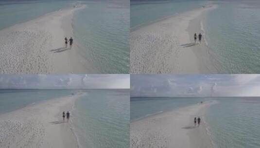 无人机拍摄情侣在沙洲行走高清在线视频素材下载