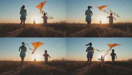 黄昏母亲和子女在户外放风筝高清在线视频素材下载