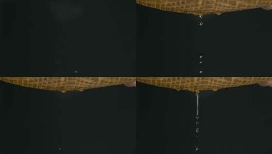 慢镜头水滴视频黑背景前光亮的水滴高清在线视频素材下载