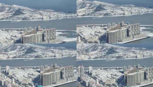 长焦航拍雪后的威海城市与雪山高清在线视频素材下载