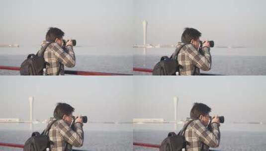 摄影师在海边举着相机拍照高清在线视频素材下载