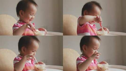 可爱小女孩学用勺子自己吃饭吃面条高清在线视频素材下载