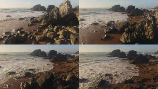 岩石海滩，粗糙的海浪拍打在红色的沙滩上高清在线视频素材下载