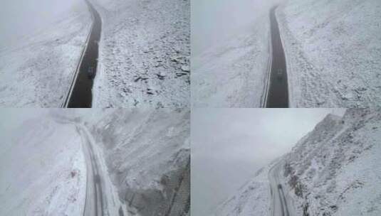 航拍在下雪天行驶在山路上的车辆高清在线视频素材下载