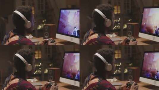 非裔美国男性玩家晚上在PC上玩FPS游戏高清在线视频素材下载