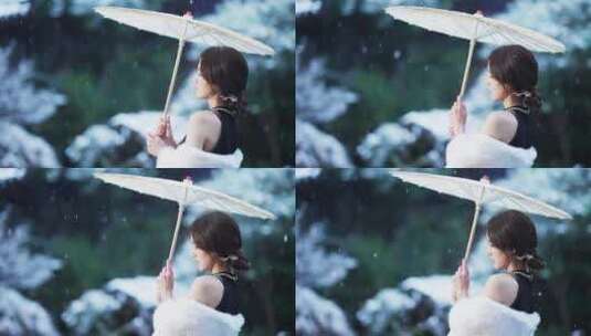 冬天下雪花纷飞打油纸伞旗袍美女在江南园林高清在线视频素材下载