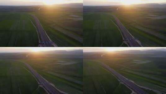 夕阳下航拍穿过麦田的高速公路高清在线视频素材下载