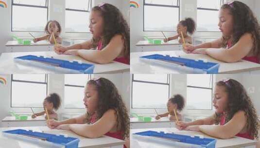 混血女孩坐在学校课桌前学习的视频高清在线视频素材下载