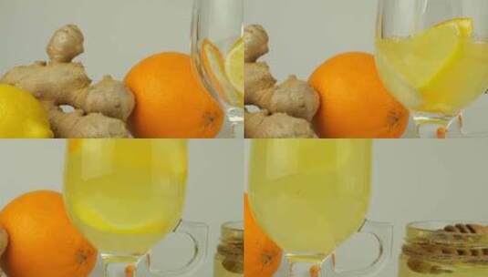 柠檬水倒入装有橙子、柠檬和姜片的玻璃杯中高清在线视频素材下载