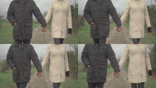 情侣手牵手在乡村小路上散步高清在线视频素材下载