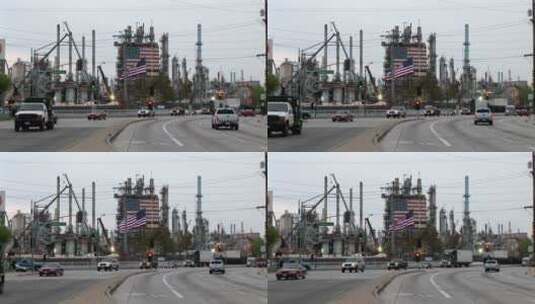 车辆经过一个装饰着两面美国国旗的工厂高清在线视频素材下载