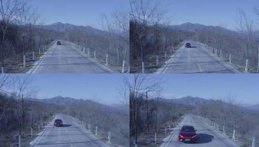 航拍山路红色汽车迎面疾驰而过 近景 移拍高清在线视频素材下载