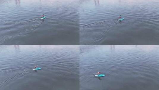 航拍长江中划船帆板运动健身的男士高清在线视频素材下载