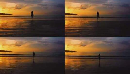 女人走在黄昏的沙滩上剪影高清在线视频素材下载