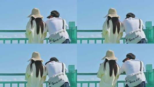 海南三亚海棠湾情侣在拍摄蔚蓝色海洋背影高清在线视频素材下载