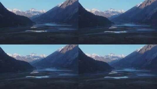 4k航拍西藏然乌湖蜿蜒的小溪湖水雪山蓝天高清在线视频素材下载