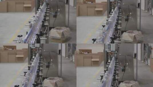 塑料瓶在机器人设备上排成一行。纸盒站在背景中。高清在线视频素材下载