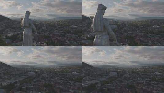 空中飞过第比利斯市的格鲁吉亚母亲雕像，日落时可以看到城市景观高清在线视频素材下载