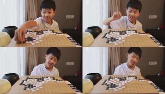 可爱的男孩在窗边下围棋高清在线视频素材下载