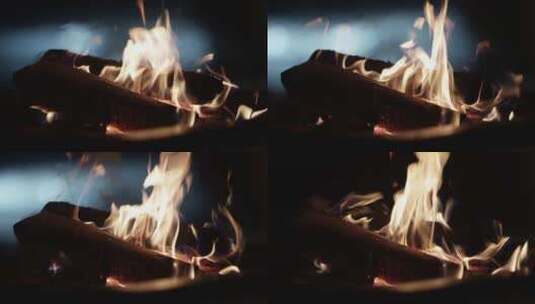 篝火上燃烧木头的特写镜头，背景是抽象的汽高清在线视频素材下载