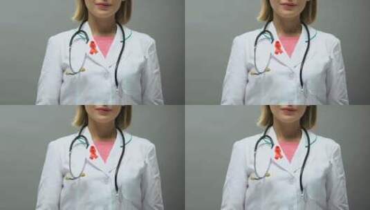 红丝带摆姿势拍照的女医生，艾滋病意识，性高清在线视频素材下载