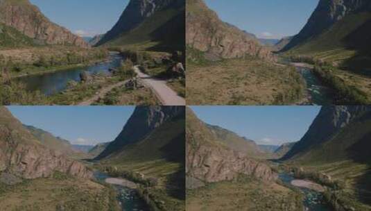 阿尔泰绿色田野和蓝色晴朗天空的山脉之间的Chulyshman河高清在线视频素材下载