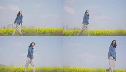 低角度拍摄美女走在春天油菜花田高清在线视频素材下载