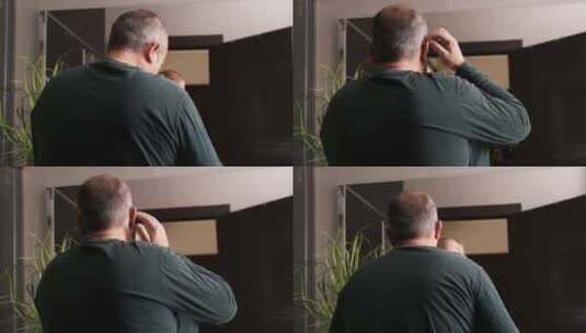 一名男子将助听器正确地放在浴室的镜子前高清在线视频素材下载
