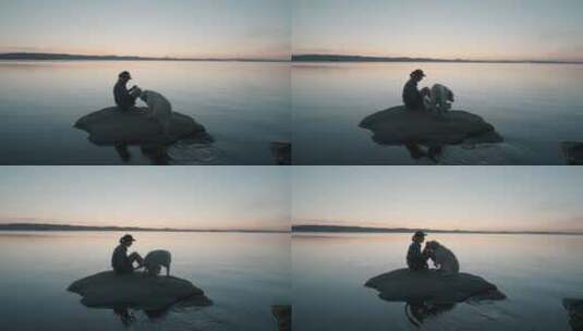 女人和狗坐在湖中的视频高清在线视频素材下载