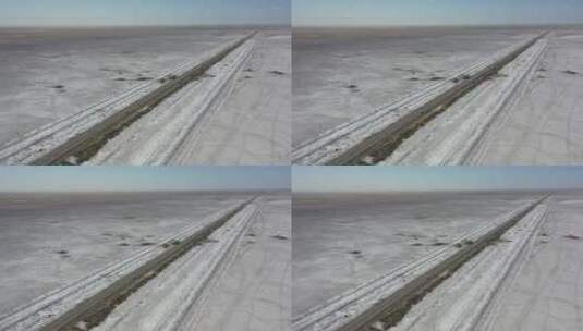 公路穿过新疆塔里木盆地荒芜的盐碱地高清在线视频素材下载