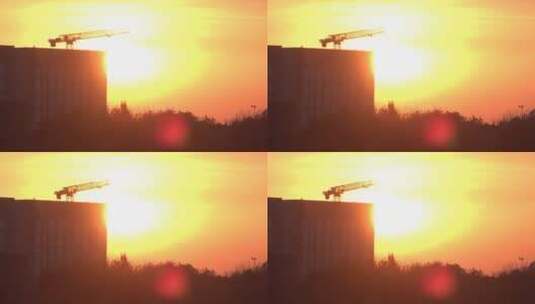 黄昏夕阳下工作的建筑吊塔高清在线视频素材下载
