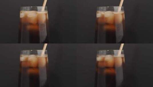 一杯黑色背景上有冰的可乐。高清在线视频素材下载