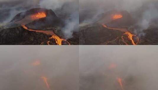 鸟瞰沸腾的熔岩湖流下火山，火山烟雾覆盖天高清在线视频素材下载