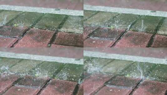 暴雨中雨滴在人行道地砖上溅起特写慢镜高清在线视频素材下载