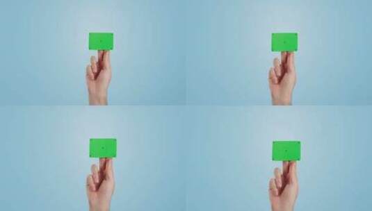 手，绿屏和名片在工作室的模型空间孤立在蓝高清在线视频素材下载