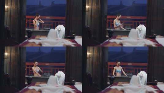 女子在温泉中放松，窗外夜景朦胧高清在线视频素材下载