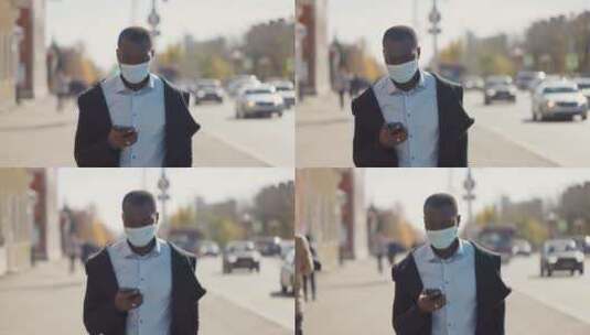 男人戴口罩在街上玩手机高清在线视频素材下载