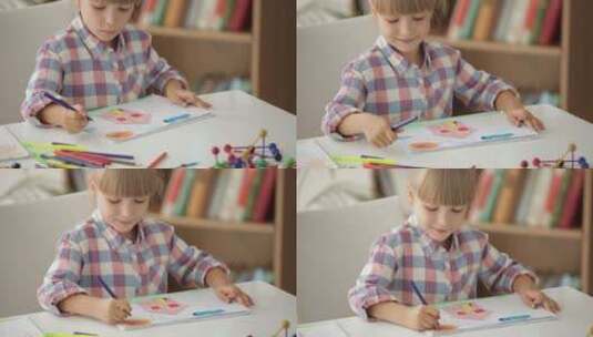 有趣的小女孩用彩色铅笔画画高清在线视频素材下载