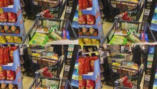 超市里的顾客和堆得满满的购物车高清在线视频素材下载