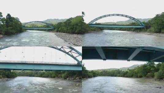 鸟瞰宽阔的河流，有一座金属桁架桥，经过桥高清在线视频素材下载
