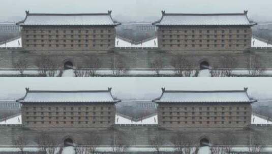 航拍陕西省西安市大雪中的西安安远门古城墙高清在线视频素材下载